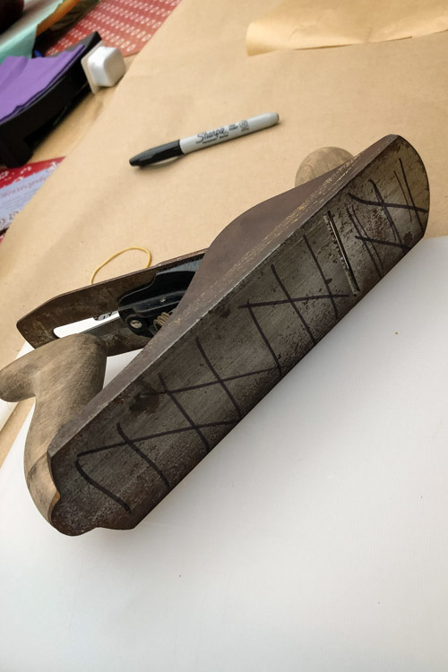 The sole is marked with lines to help see what material is removed during flattening